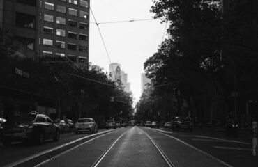 A street view of the sun setting in a city