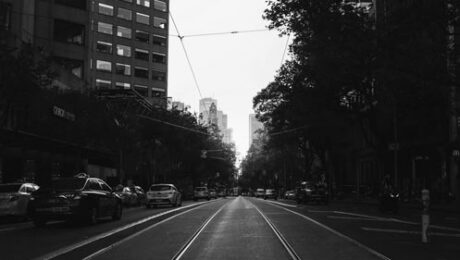 A street view of the sun setting in a city