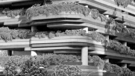 A high rise building with overflowing greenery