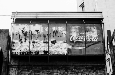 Image of a decaying Coca-Cola sign in Asia