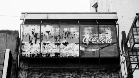 Image of a decaying Coca-Cola sign in Asia